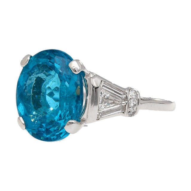 5.87 Carat Oval Cut Apatite and Diamond Platinum Cocktail Ring. The bright ocean blue apatite gemstone, sits in the center...