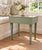 Charming primitive farmhouse table finished in a soft sage green with lightly distressed edges that reveal the natural...