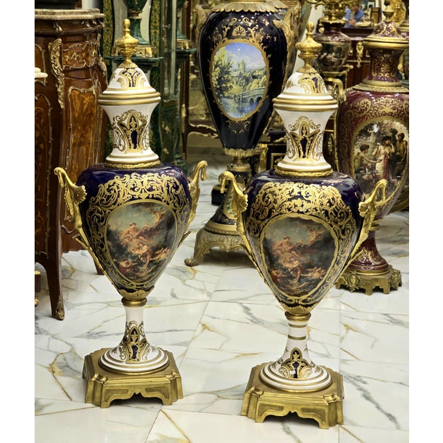 Elegant pair of French porcelain vases, decorated with a multicolored background and delicate galant scenes in reserve....
