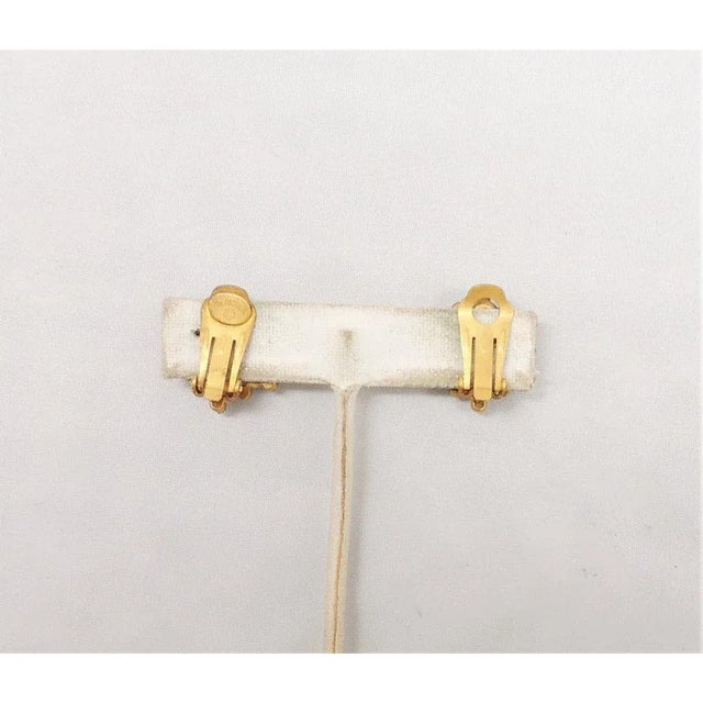 This is part of Chairish’s Costume Jewelry assortment. Circa 1960s goldtone faux-pearl studded center with small clear...