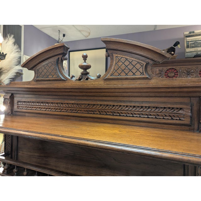 French Buffet two tier. Carved French Walnut with a marble top. The two doors are detailed with carved flower baskets....