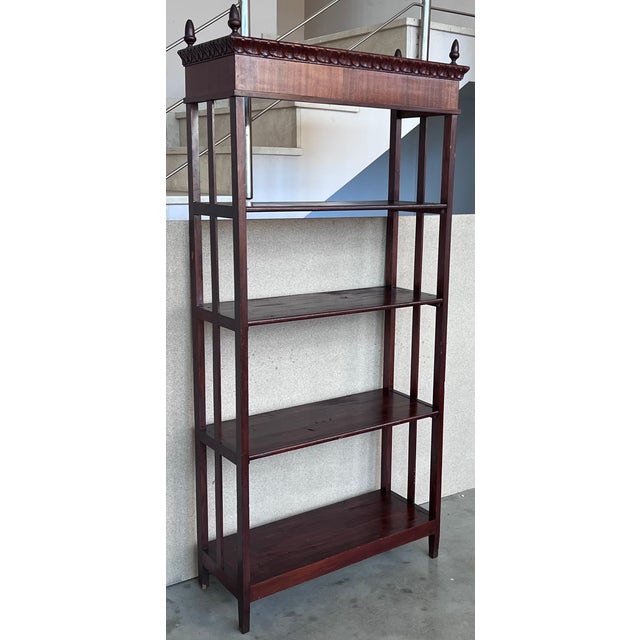 This tall late nineteenth century French Empire style walnut console table features columns at the front corners and four...