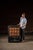 An antique wooden cabinet featuring 14 pull drawers, supported by rolling caster wheels. The majority of the cabinet...