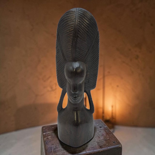 This hand-carved iron wood African sculpture tribal art bust is a unique and authentic piece of art created by a skilled...