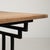 A French 20th century cast iron bistro table with an oak top, exemplifying the enduring appeal of café-style furniture....