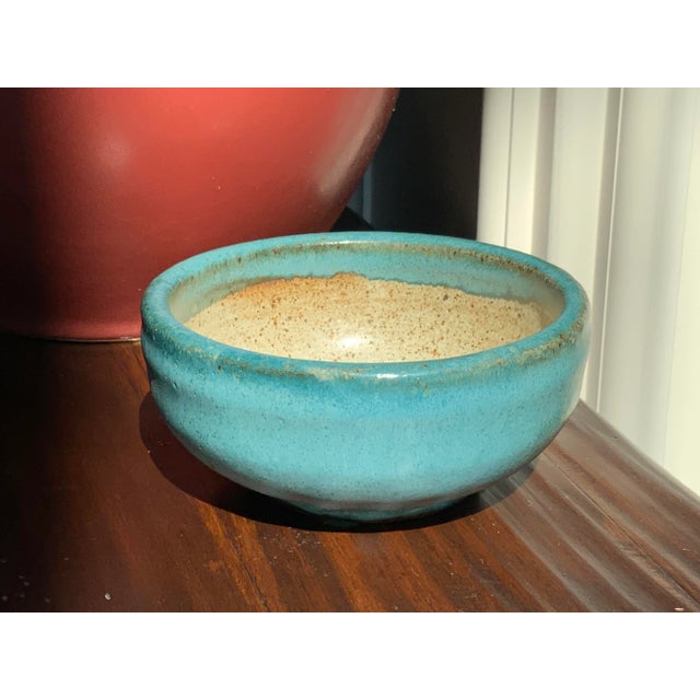 The artist has signed the piece “Von”. Her name is Yvonne Holland from Durango Colorado. The Cyan blue-green color is...