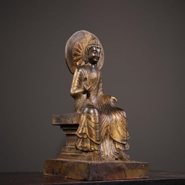 This is a beautifully detailed, antique-style Chinese bronze figure of Shakyamuni Buddha. The Buddha is seated in a...