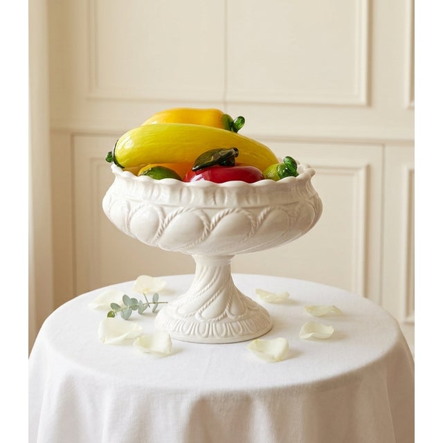 An exquisite 7-piece vintage table centerpiece featuring a classic Italian glazed ceramic pedestal compote bowl filled...
