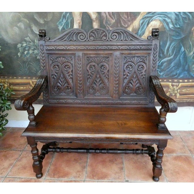 Early Victorian Carved Country Oak Settle, circa 1830–1840 Material: Country oak and fabric upholstery A substantial early...