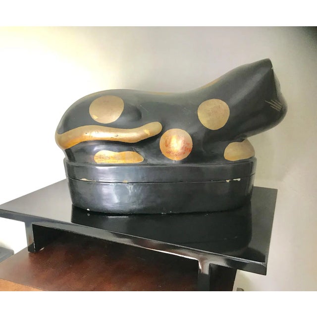 What a rare find! This vintage Chinese wooden pillow box is a shaped like a lying cat, opens to a box for hidden treasures...