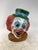 Charming decorative sculpture depicting a smiling clown wearing a colorful top hat, finished with hand-painted details and...