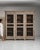 Cerused oak mesh-front cabinet in Weathered Whitewash. Its weathered whitewash finish sets off woven metal mesh door...
