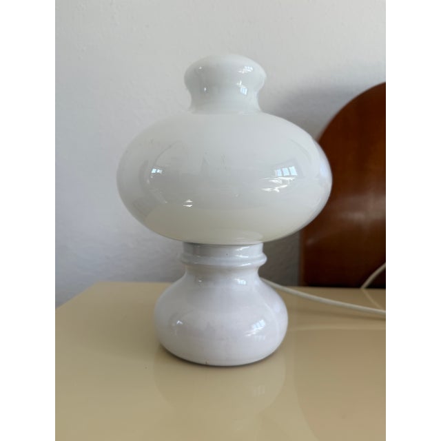 Striking Space Age table lamp from the 1970s, featuring a sculptural, mushroom-inspired silhouette. Crafted from glossy...