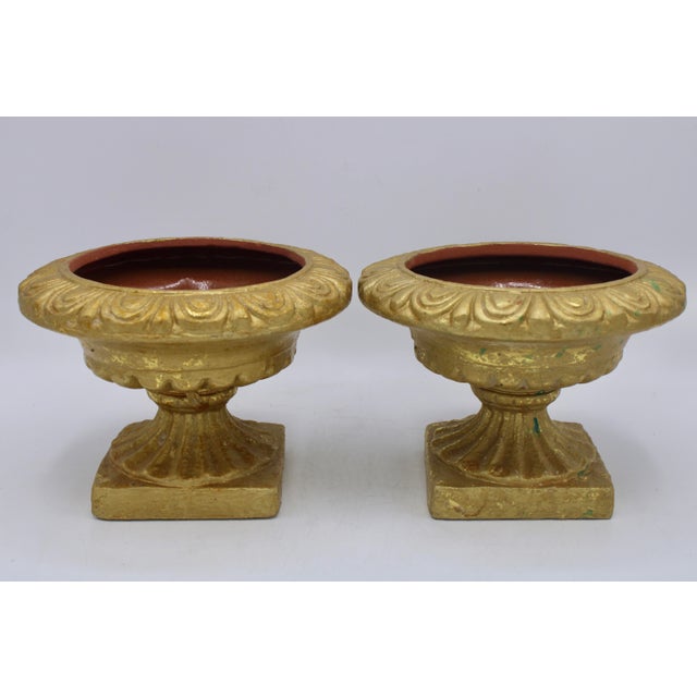 A stunning pair of two ceramic (terra cotta) gold gilded urns, mid-20th century, Italian. This is such lovely pair with...