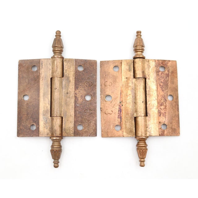 These Victorian style door hinges are made of brass with steeple tips, three knuckles, and a template hole pattern. The...