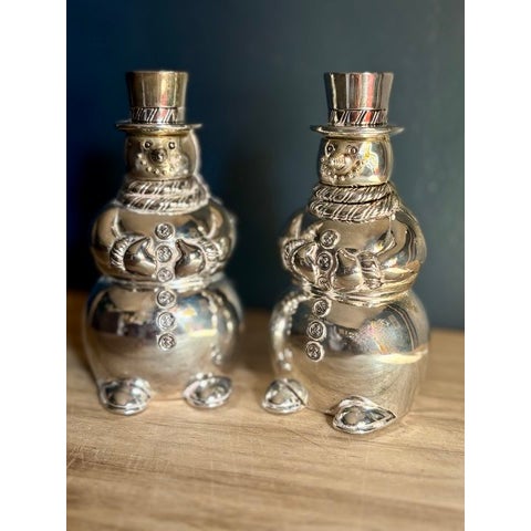A pair of snowman salt and pepper shakers by International Silver Company, finished in bright silverplate. Both shakers...