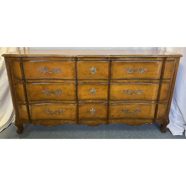 Very pretty French provincial style dresser by Bodart Furniture. The nine drawer dresser has superior craftmanship with a...