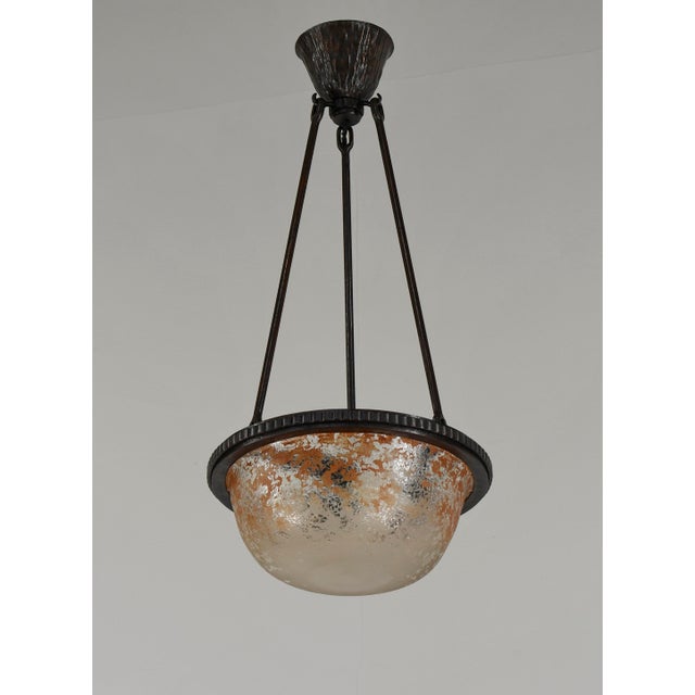 DAUM A small and very rare pendant chandelier by Daum frères. Made around 1925-1930. A wonderful wrought iron mounting...