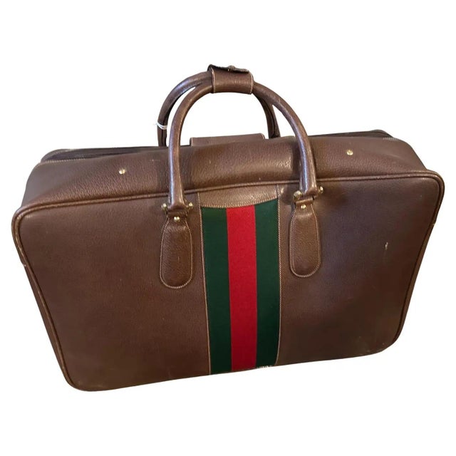 This authentic and beautifully preserved 1970s Gucci suitcase is a classic and highly sought-after piece. Crafted in...