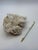 Sculptural natural white quartz crystal cluster featuring sparkling crystalline formations over a raw stone matrix. Its...
