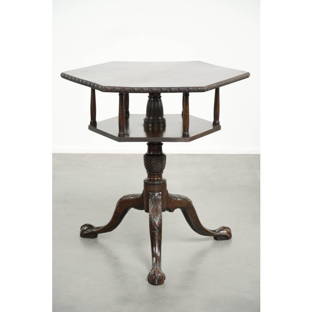 This charming antique wooden English swivel book table/side table dates from the 19th century and features a hexagonal...