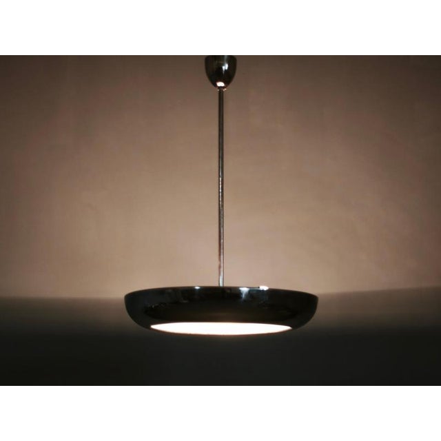 Rare bauhaus and modernist pendant light from 1930s czechoslovakia, distinguished by its exceptionally clean ufo-shaped...