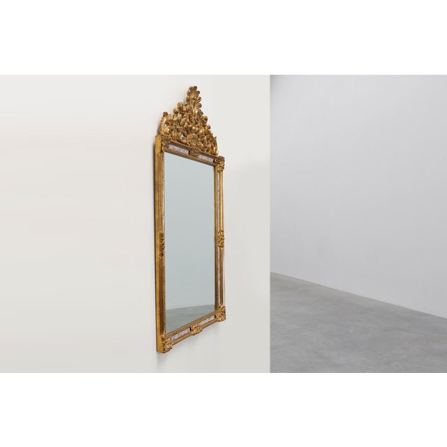 Elegant Belgian wall mirror by Deknudt, executed in the Régence style and distinguished by its richly ornamented openwork...