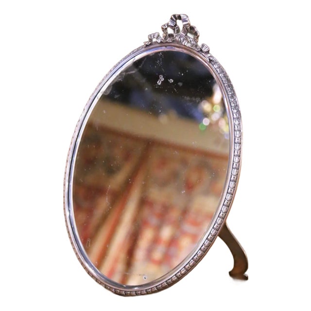 Early 20th Century French Silverplated Over Nickel Vanity Mirror With Bow Crest For Sale