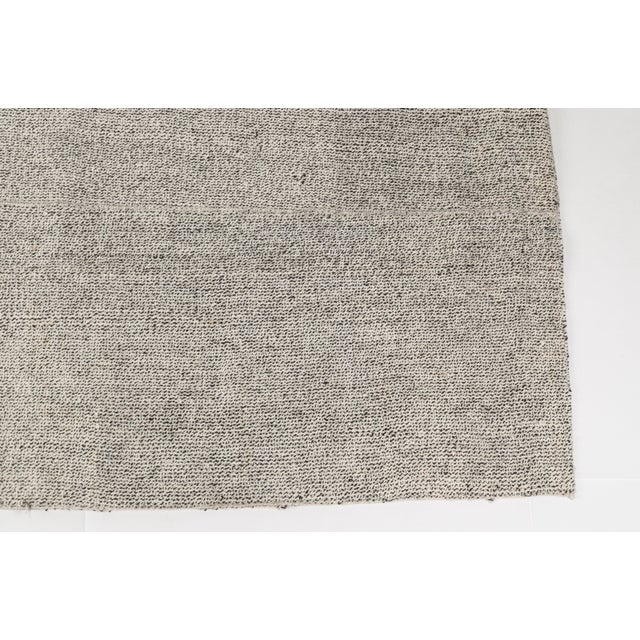 This is a vintage Turkish Oushak rug from the Mid 20th Century. The piece was hand-knotted.