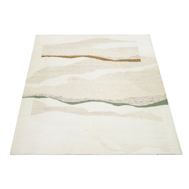 This beautiful modern Soumak hand-knotted wool rug has an Ivory field. It features green and golden-brown accents in a...