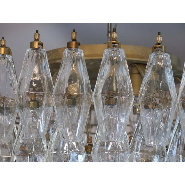 Elegant Italian ceiling light made from 84 beautiful Murano trasparent glasses "poliedri". Structure in gold and brass...