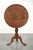 This charming antique English tilt-top table dates from the 19th century and features beautiful colors and a stunning...