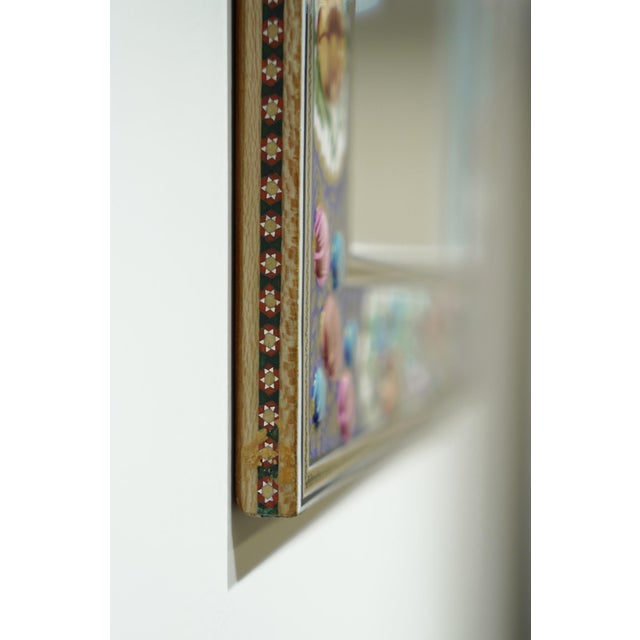 This hand-painted decorative mirror features a vivid bird and floral frame inspired by traditional ornamental painting....