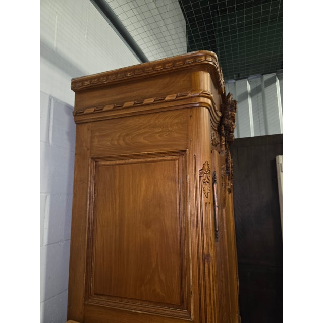 vintage reproduction of a French Provincial or Louis XV style armoire, antique. piece is characterized by a carved floral...