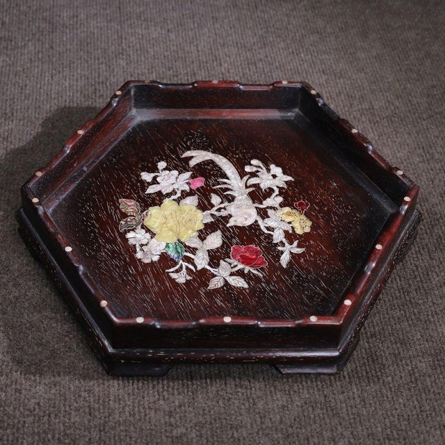 A beautiful Chinese hexagonal tray or display stand, likely made of rosewood (Hongmu). The center of the tray is...