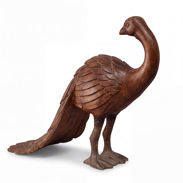 This is a large scale mid-century Indian carved hardwood folk art standing peacock sculpture. He has a carved sweeping...
