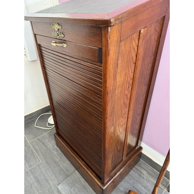 Oak roll-top cabinet, 1930s The highlight is the smooth-running roll-top door, which slides upwards to save space. with a...