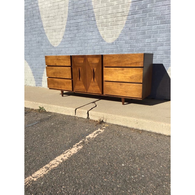 Elegant mid-century modern dresser by American of Martinsville, featuring rich walnut construction and striking geometric...