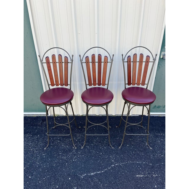 A beautiful set of 3 Walter E Smith swivel bar stool. Crafted with wrought iron with a hammered finish, these bar stools...