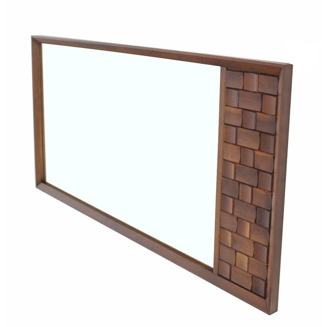 Nice large vintage mid-century modern mirror with solid walnut decorative carving panel. Inspected vintage condition.