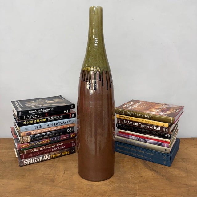 "About This Piece About This Piece This vase makes a statement of bold artistry, its surface alive with the drama of...