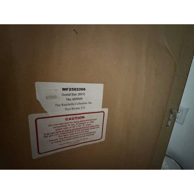 This wall mirror is a highly ornate, symmetrical and floral/scroll based design.