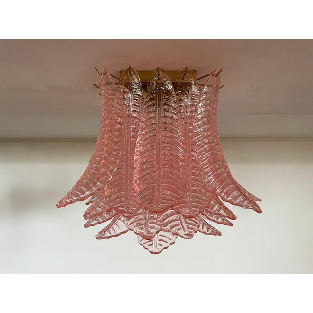 Spectacular ceiling lamp with 32 Murano pink leaves in golden painted metal frame. Elegant lighting object. Period: late...