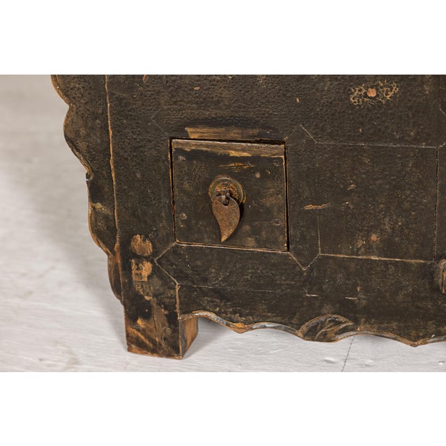 A low Kang Qing Dynasty period sideboard from the 19th century with brown distressed finish, two small doors, two small...