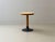 An elegant side or bistro table with a clean, timeless design and a beautiful combination of wood and black lacquered cast...