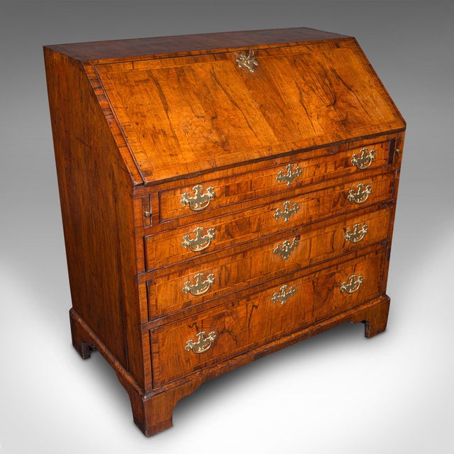 This is an antique gentleman's bureau. A fine English, walnut writing desk or secretaire, dating to the Georgian period,...