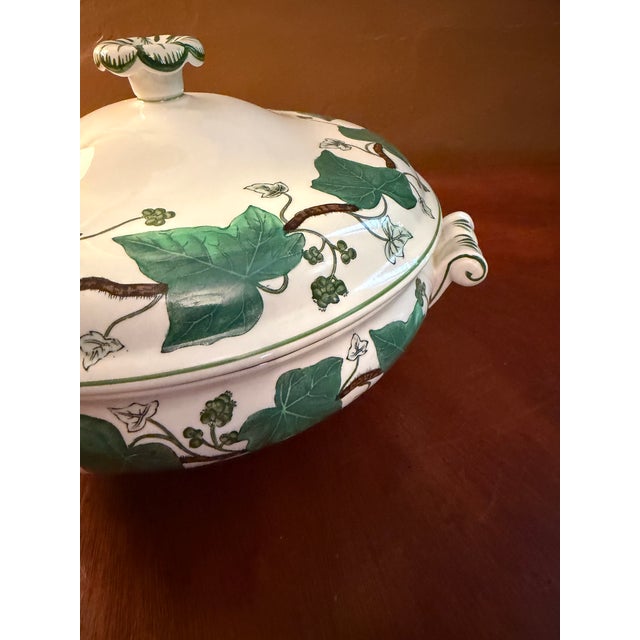 The Wedgwood Napoleon Ivy Queensware Covered Serving Bowl is a luxurious and elegant piece of bone china that adds a touch...