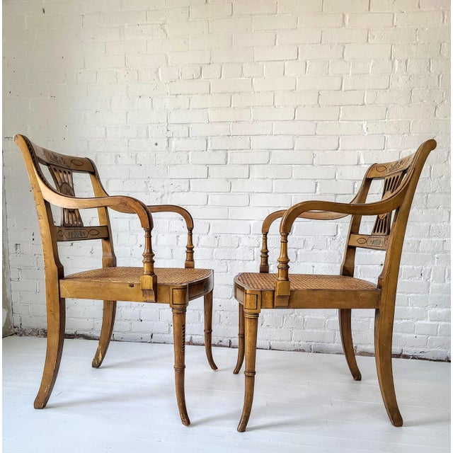 Lovely pair of Mid Century Sheraton style arm chairs in original hand painted decoration. The floral medallions are pink...