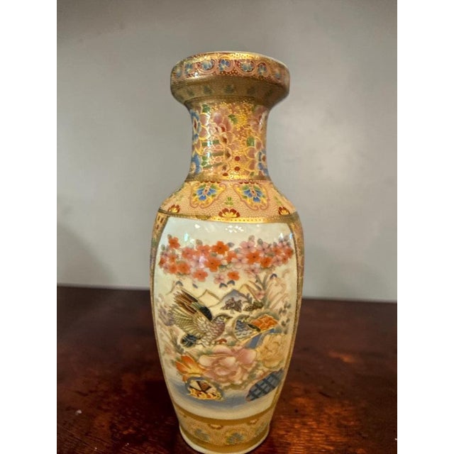 Japanese Satsuma Vase with Extensive Gilt Decoration and Floral Landscape Scene, Early 20th Century An elegant Japanese...