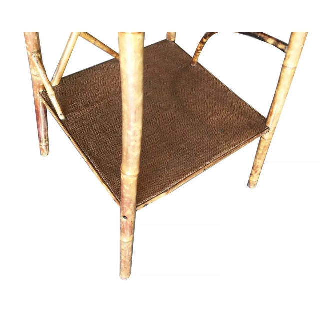Antique tiger bamboo pedestal side table with rice mat top organically formed accents and secondary bottom shelf. 1930,...